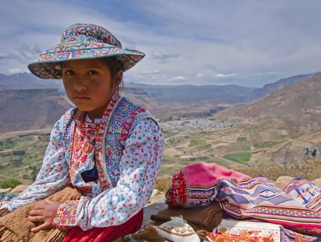 Young Peruvian girl selling local hand-made goods in the Colca Canyon.