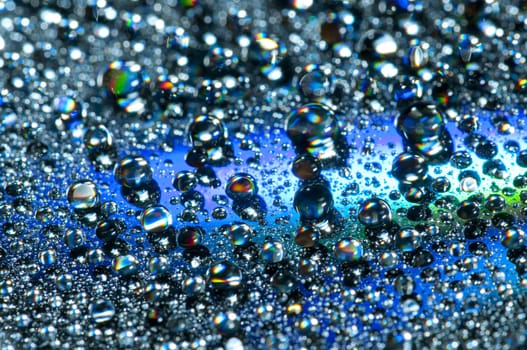 Water drops on colorful reflective surface