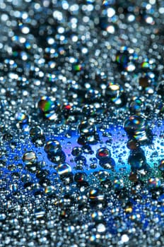 Water drops on colorful reflective surface