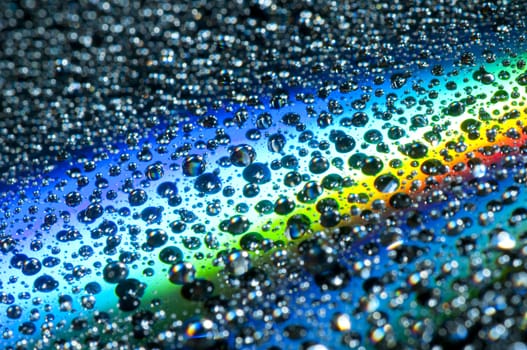 Water drops on colorful reflective surface