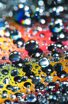 Water drops on colorful reflective surface