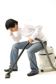 man sitting and thinking on a vacuum cleaner looking tired and depressed