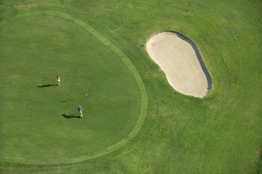 Aerial view of two people playing golf at Bald Head Island, North Carolina.