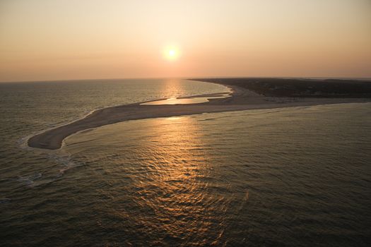 Aerial view of sun over Atlantic ocean and shoreline of Bald Head Island, North Carolina.