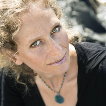 Caucasian mid-adult woman with wavy hair looking at viewer.