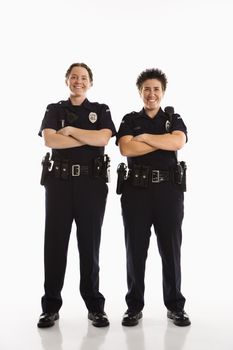 Portrait of two mid adult Caucasian policewomen standing with arms crossed looking at viewer smiling.