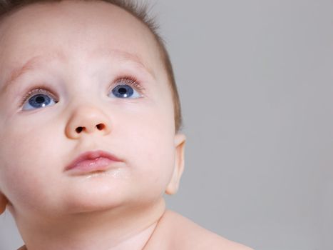 Curious baby boy looking up