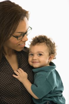 African American mid adult mom holding toddler son who is looking at viewer.