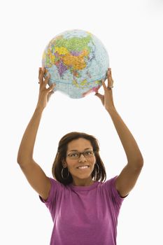 African American mid adult woman holding globe over head and smiling at viewer.