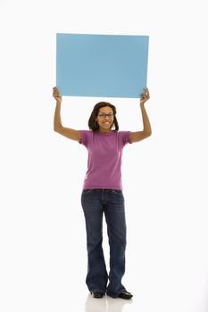 African American mid adult woman holding sign over head smiling at viewer.
