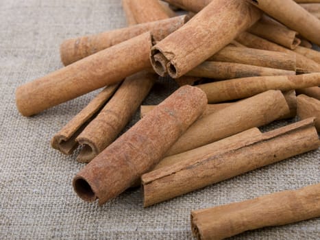 Closeup picture of aromatic cinnamon on linen background