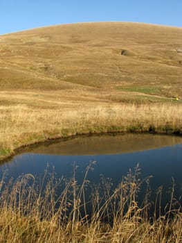 The nature; caucasus; mountains; a panorama; a landscape; lake; water; a reservoir; the sky; reflexion; the bright; a background; a kind; beauty; reserve; morning, the Alpine meadows, a hill, a grass, a glade, a field