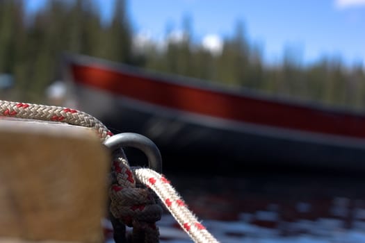photo of close-up cord with blurry boat

