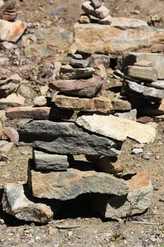 Stone inukshuk in rocky mountains in summer time
