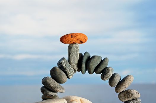 Arch from dark stones and a red stone from above