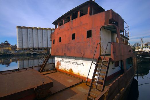 Rusted Boat at Shipyard, in the Riachuelo in La Boca, Buenos Aires, Argentina. The neighborhood of La Boca is a popular tourist destination in Argentina.