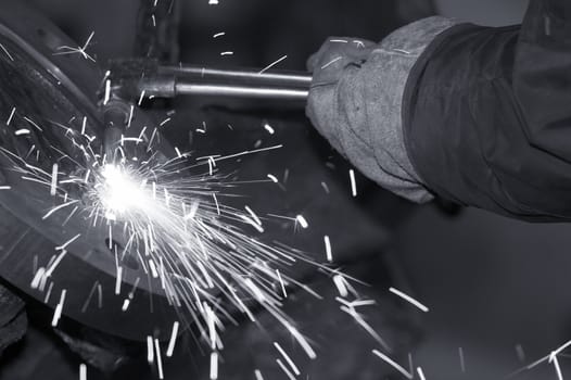 a close picture of a torch cutting steel