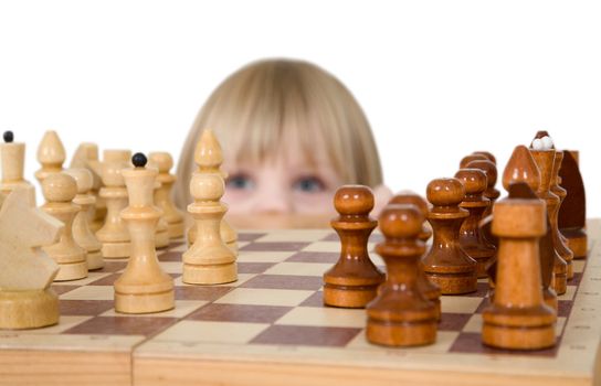 Little girl looking chess on the white background