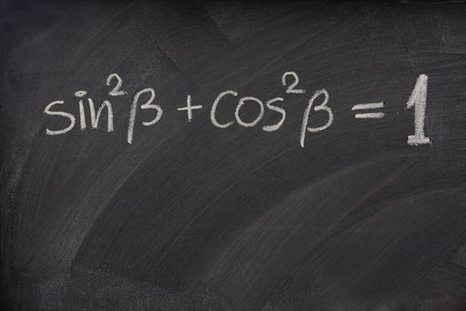 Pythagorean trigonometric identity handwritten with white chalk on a blackboard