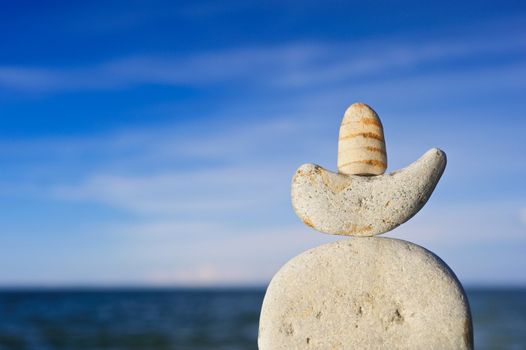 Sea pebble against the dark blue sky in the summer on a beach