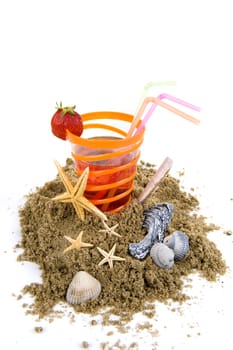 sand with a glass lemonade and sea shelves