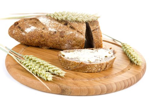 nut bread, butter and grain on a cutting board