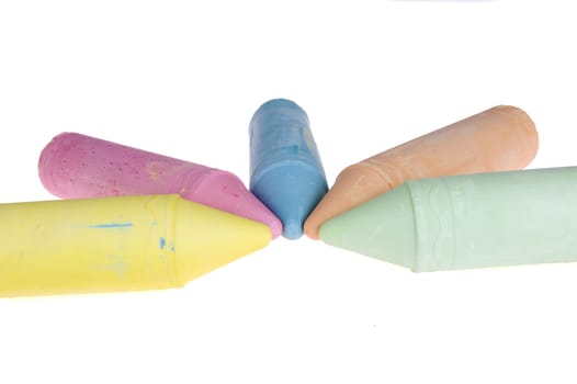 five colorful chalks on a white background