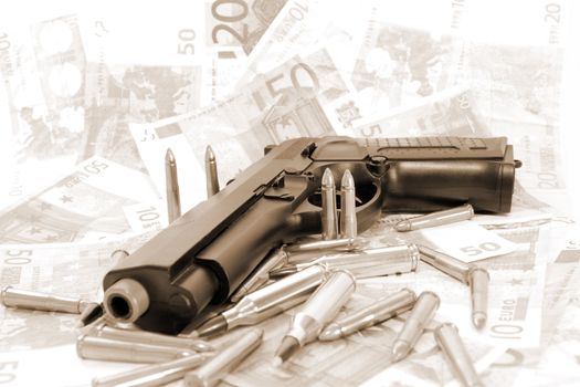 gun bullets and money showing a dangerous side to life