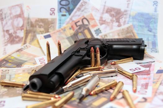 gun bullets and money showing a dangerous side to life