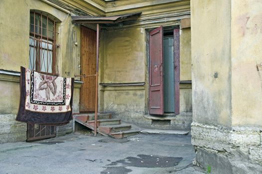 Doorway to old apartment building in city outskirts