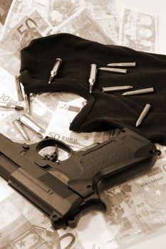 balaclava money a gun and bullets showing concept of a robber or terrorist activity