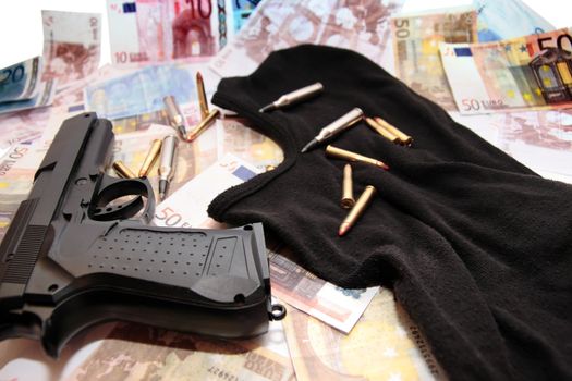 balaclava money gun and bullets showing a concept of a robbers or terrorists activity