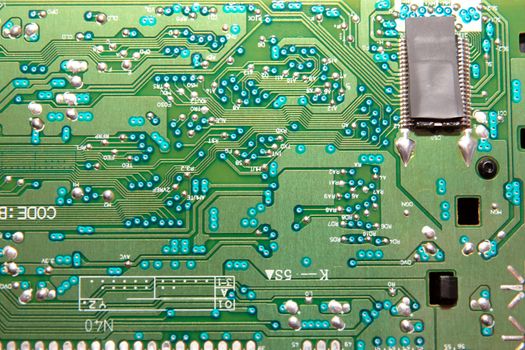 close up of a green and blue printed circuit board