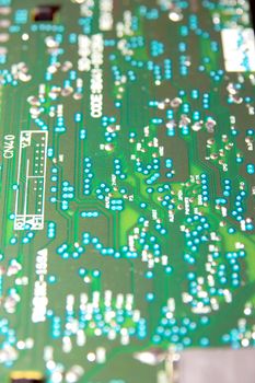 close up of a green and blue printed circuit board