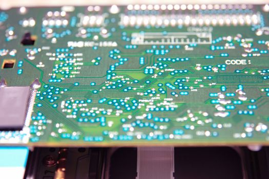 close up of a green and blue printed circuit board
