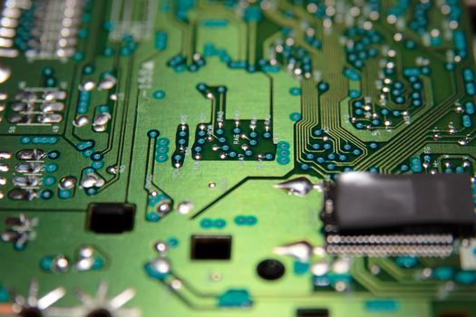 close up of a green and blue printed circuit board