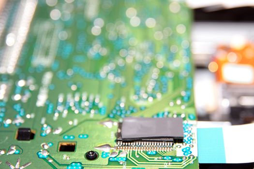close up of a green and blue printed circuit board