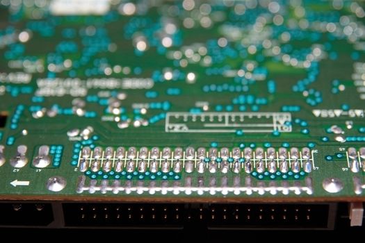 close up of a green and blue printed circuit board