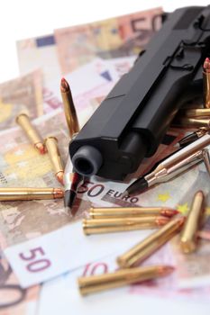 gun, bullets and money showing a dangerous side to life