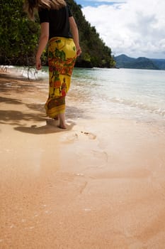 A female walking on the beach
