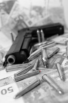 gun bullets and money showing a dangerous side to life