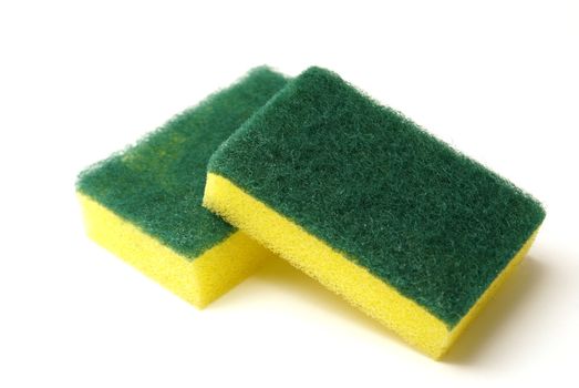 A couple of cleaning sponges with two scrubbing sides.