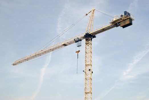 A construction crane isolated on a sky background.