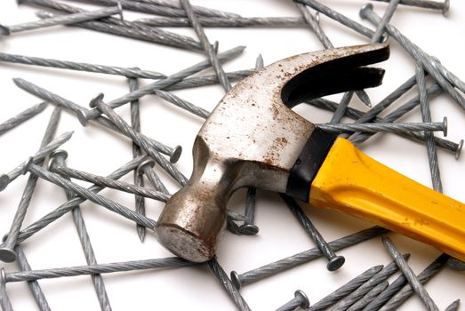 A macro shot of a hammer and nails.