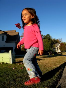 Little girl playing in the suburban neighborhood