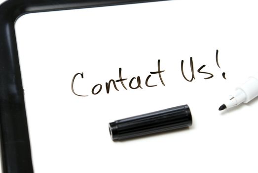 Contact us is hand written in black marker on an office whiteboard.