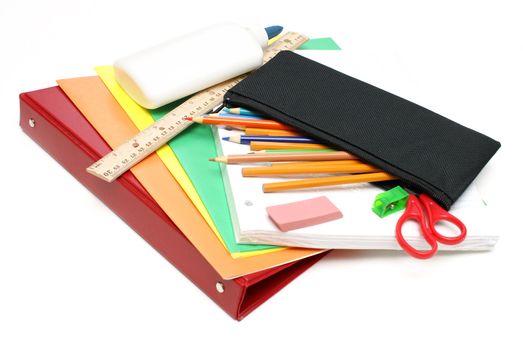 An isolated group of various school supplies.