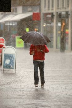 Man is running in the rain. Motion blur.