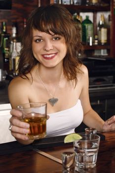 Photo of a beautiful bartender serving you a glass of whisky.