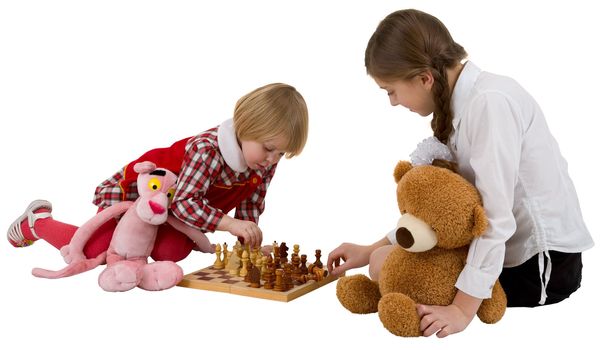 Girls play chess and toy panther and bear